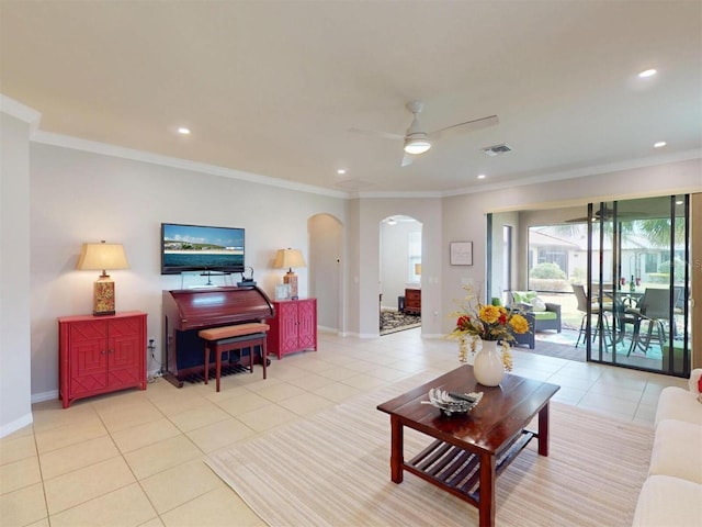 tiled living room featuring visible vents, recessed lighting, arched walkways, crown molding, and baseboards