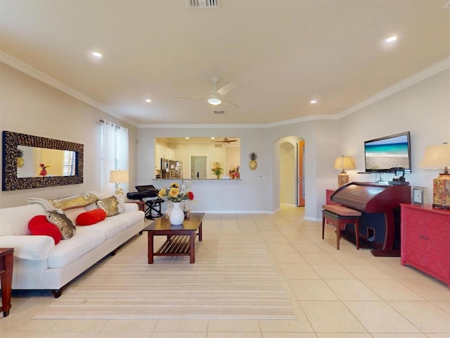 living room featuring crown molding, light tile patterned floors, recessed lighting, arched walkways, and a ceiling fan