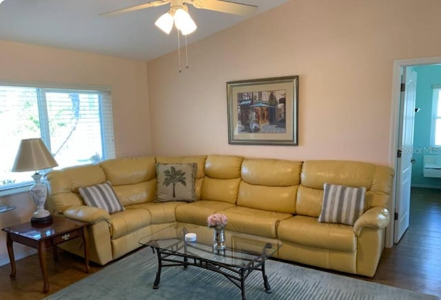 living area with wood finished floors, a ceiling fan, and vaulted ceiling