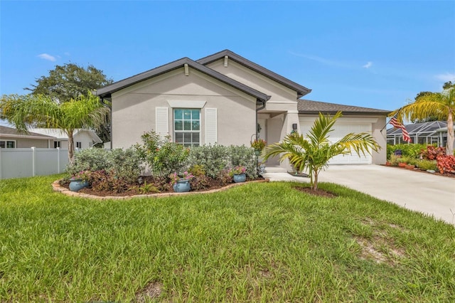 view of front of house with fence, concrete driveway, a front yard, stucco siding, and a garage