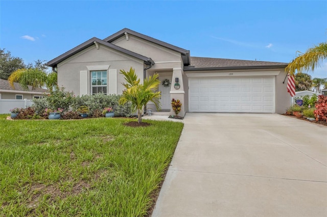 ranch-style house with concrete driveway, a garage, a front yard, and stucco siding