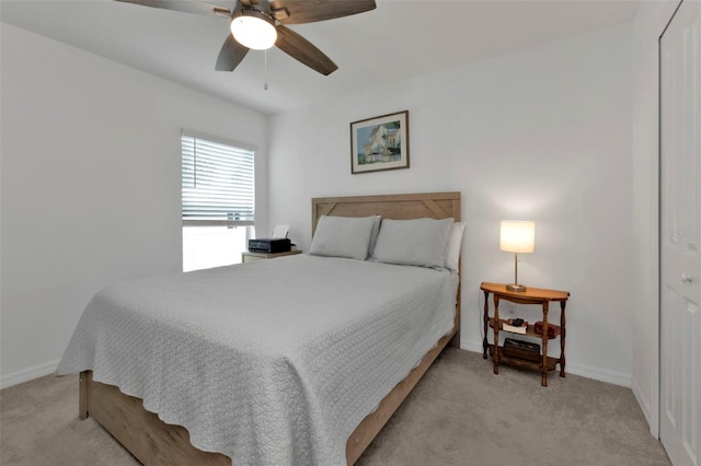 carpeted bedroom with baseboards and ceiling fan