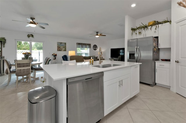 kitchen with light tile patterned floors, plenty of natural light, stainless steel appliances, and a sink