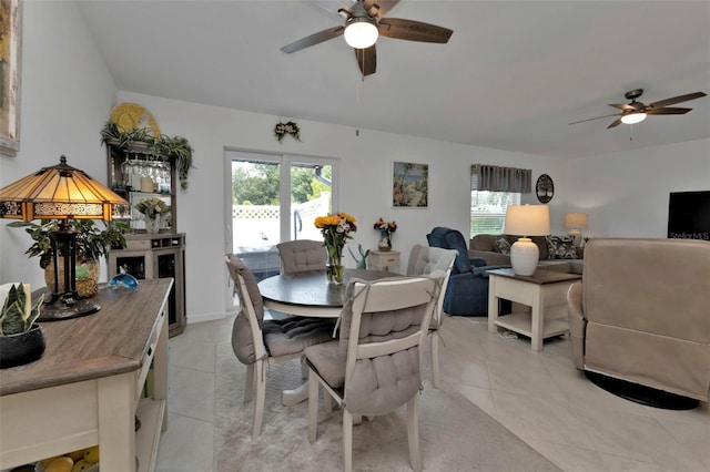 dining space featuring light tile patterned flooring and a ceiling fan