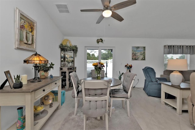 dining space with light tile patterned floors, visible vents, and a ceiling fan