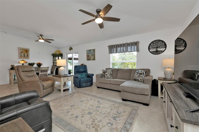 living room with vaulted ceiling, light tile patterned flooring, and ceiling fan