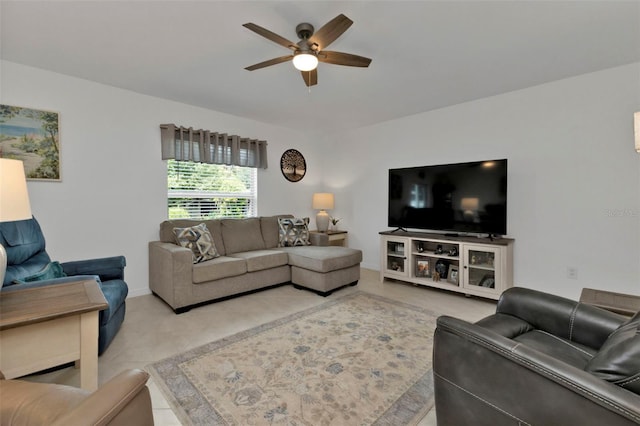 living room featuring baseboards and a ceiling fan