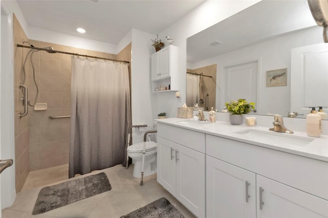 bathroom with a sink and a tile shower