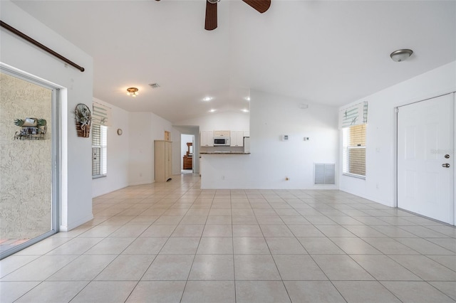 unfurnished living room featuring light tile patterned flooring, visible vents, and lofted ceiling