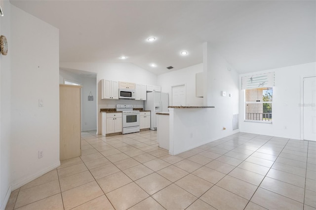 kitchen featuring white appliances, lofted ceiling, and light tile patterned flooring