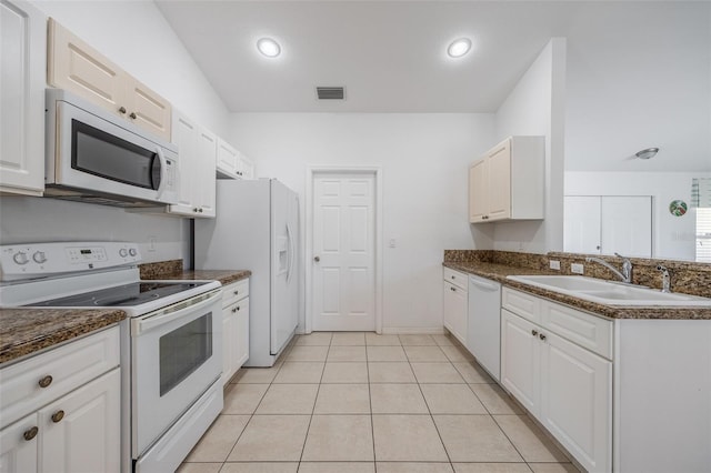 kitchen with white cabinetry, white appliances, visible vents, and a sink