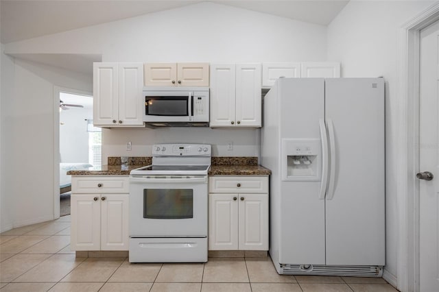 kitchen featuring light tile patterned floors, white appliances, white cabinetry, and lofted ceiling