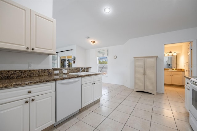 kitchen featuring light tile patterned floors, white appliances, white cabinetry, and a sink