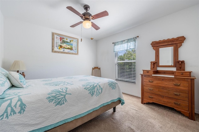 bedroom featuring light carpet and a ceiling fan