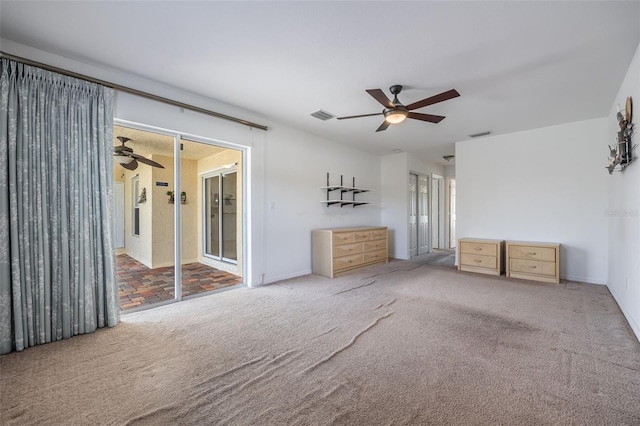 unfurnished bedroom with visible vents, a ceiling fan, and carpet