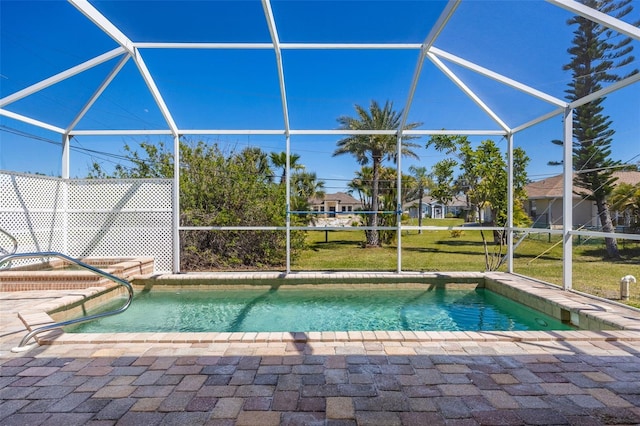 outdoor pool featuring a lanai, a yard, and a patio