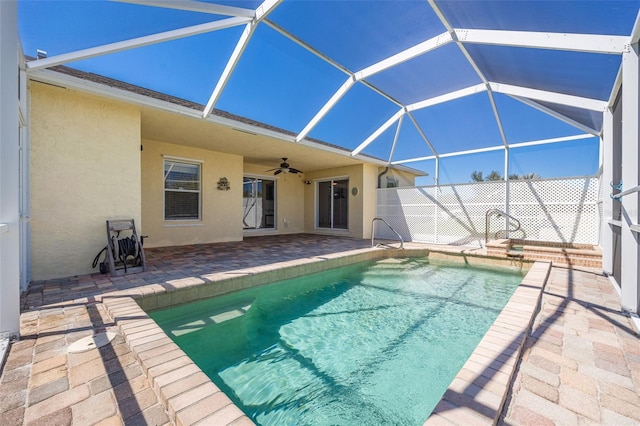 view of pool featuring a patio area, a fenced in pool, a lanai, and a ceiling fan