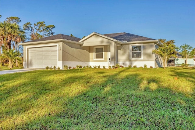 ranch-style home featuring a front yard, an attached garage, driveway, and stucco siding