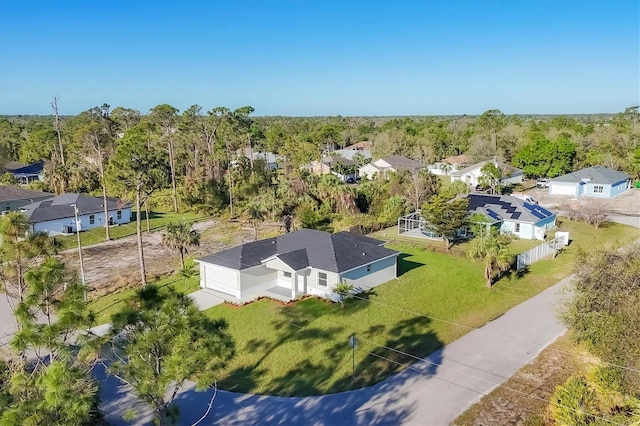 birds eye view of property with a forest view and a residential view