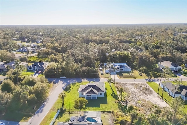 bird's eye view featuring a residential view and a forest view