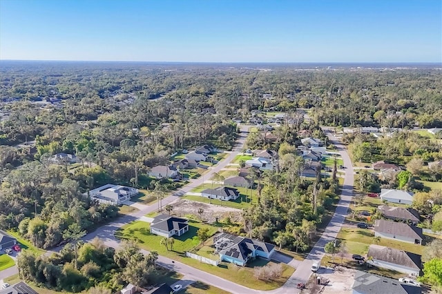 bird's eye view featuring a forest view and a residential view