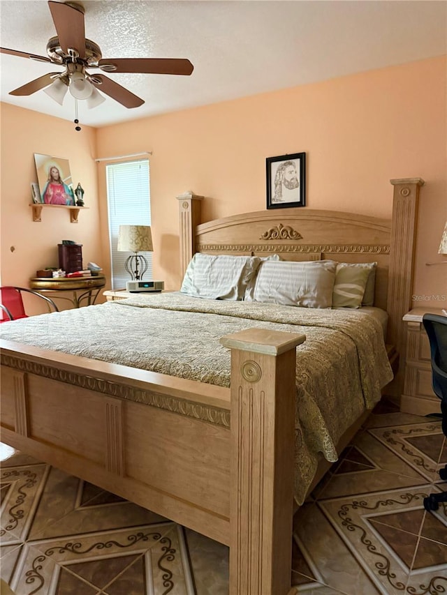 bedroom with tile patterned flooring and ceiling fan