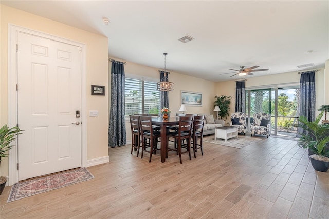 dining area with visible vents, plenty of natural light, and light wood-style floors