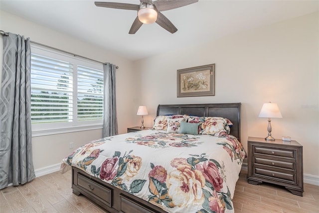 bedroom featuring ceiling fan, baseboards, and wood tiled floor