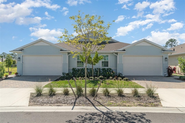 single story home with decorative driveway and an attached garage