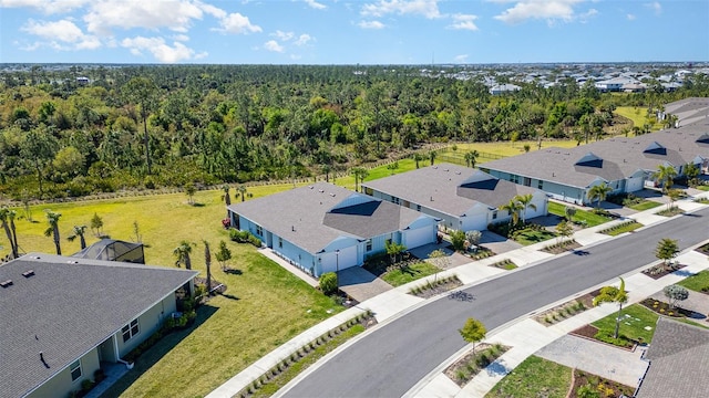 aerial view with a residential view and a view of trees