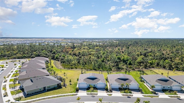 bird's eye view featuring a wooded view and a residential view