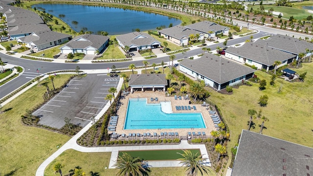 birds eye view of property with a residential view and a water view