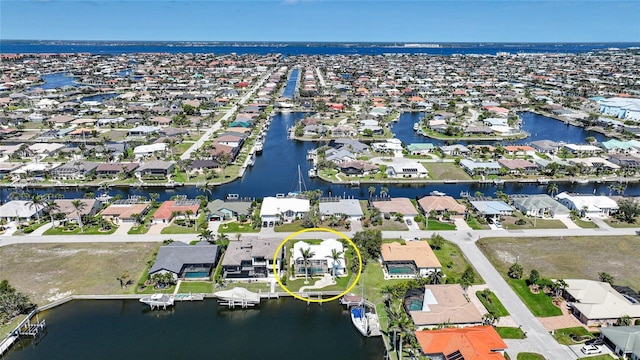 drone / aerial view with a residential view and a water view