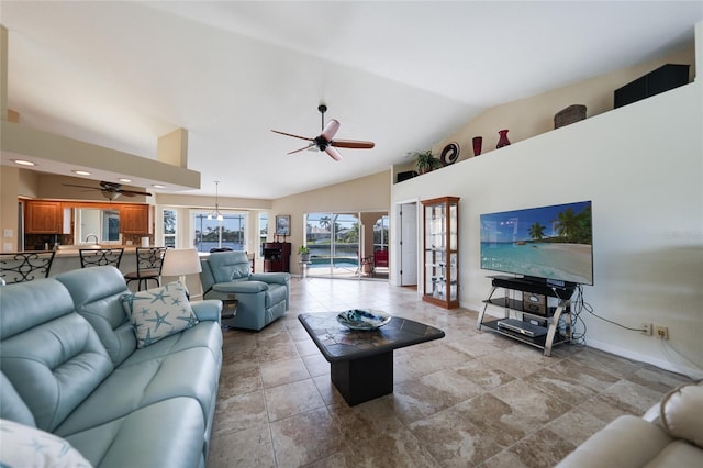 living area featuring a ceiling fan, baseboards, and high vaulted ceiling