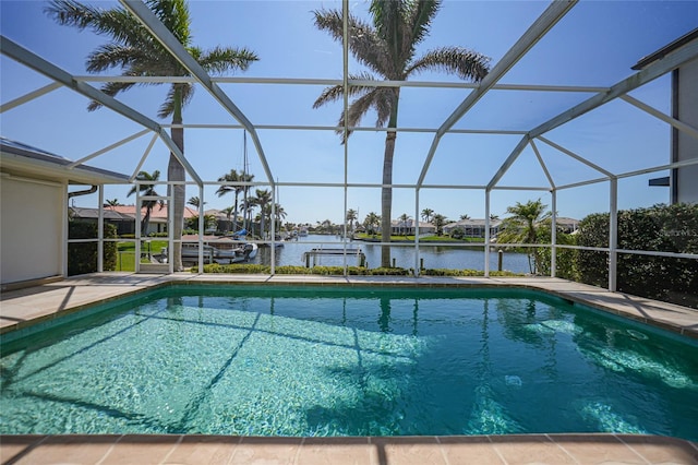 pool with glass enclosure, a dock, a patio area, and a water view