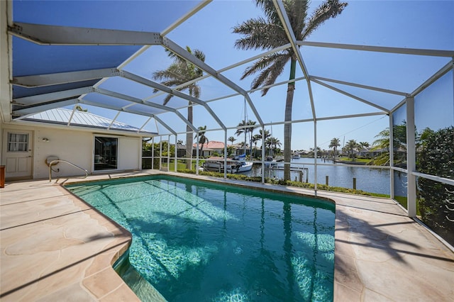 pool with a water view, a lanai, and a patio area