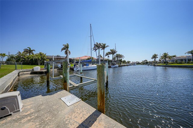 view of dock with boat lift and a water view