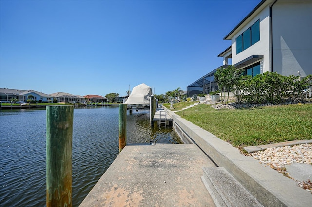 view of dock featuring a yard, a water view, and a residential view