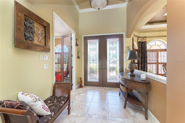 entrance foyer with french doors, baseboards, and ornamental molding