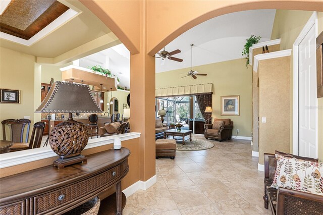 corridor featuring arched walkways and baseboards