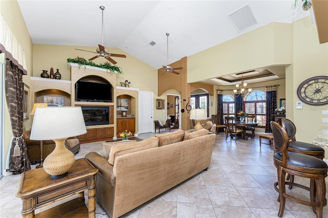 living area featuring arched walkways, visible vents, ceiling fan with notable chandelier, and high vaulted ceiling