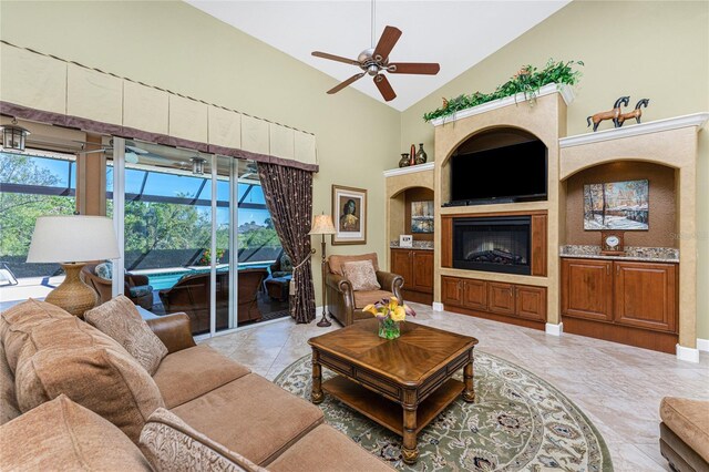 living room featuring high vaulted ceiling, a fireplace, and a ceiling fan