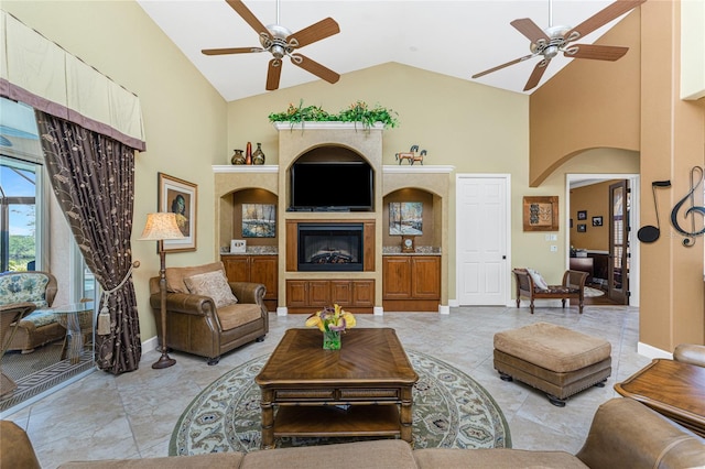 living room featuring arched walkways, a glass covered fireplace, high vaulted ceiling, and ceiling fan