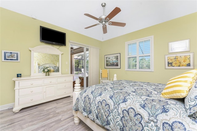 bedroom featuring access to exterior, a ceiling fan, baseboards, and wood finished floors