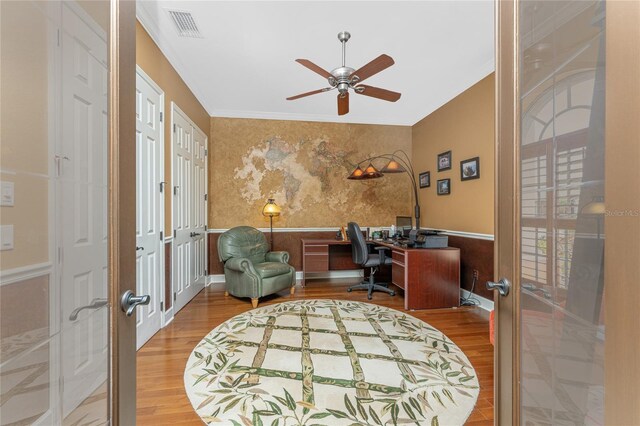 office space with french doors, wood finished floors, wainscoting, and crown molding