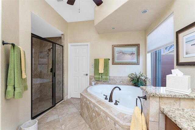 bathroom featuring vanity, a stall shower, and a whirlpool tub