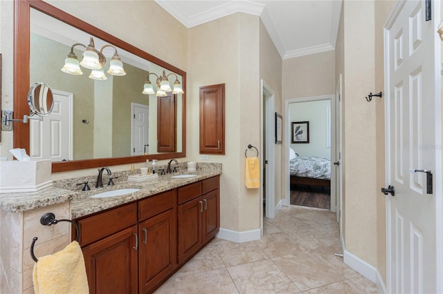 ensuite bathroom featuring double vanity, crown molding, baseboards, and a sink