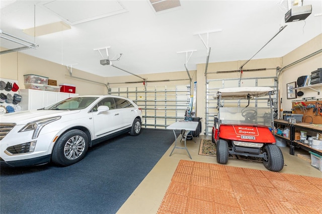 garage with visible vents and a garage door opener