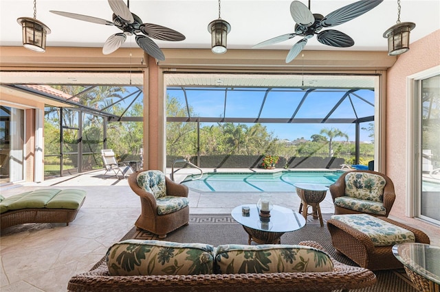 sunroom featuring a pool and ceiling fan