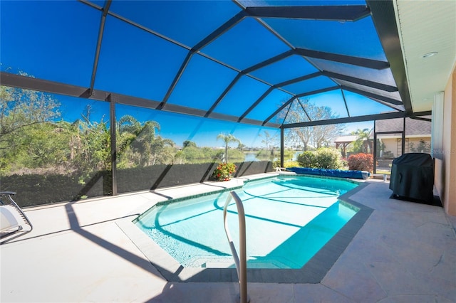 pool featuring a patio area, grilling area, and glass enclosure